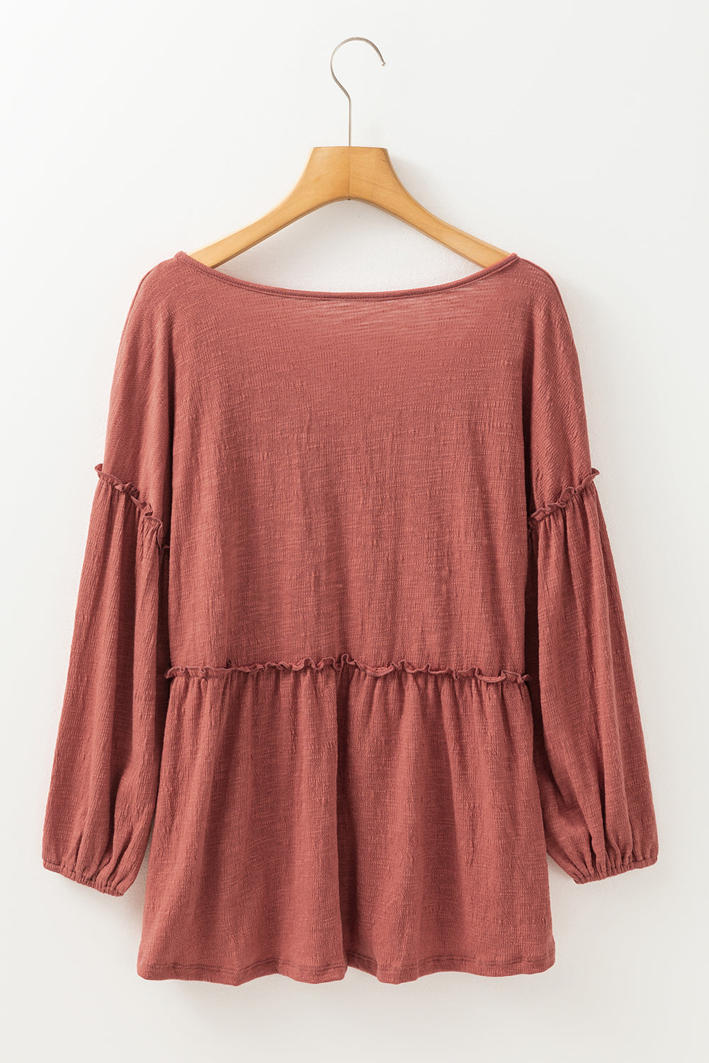 Boho Frill Long Sleeve Blouse in rust color on hanger.