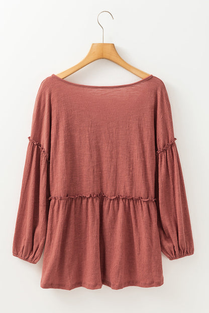 Boho Frill Long Sleeve Blouse in rust color on hanger.