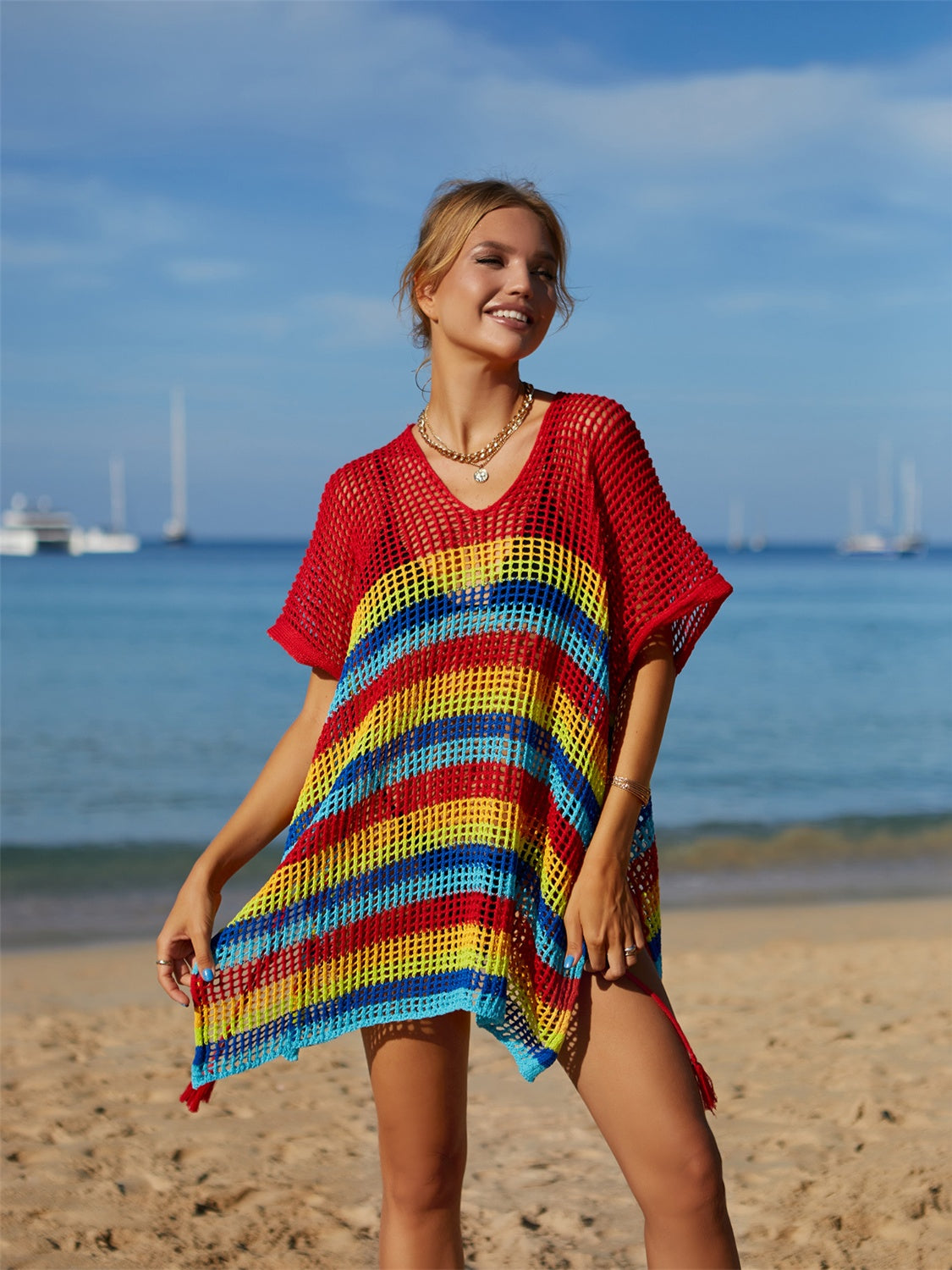 Rainbow cutout striped swim cover up with slit and semi-sheer design on the beach.