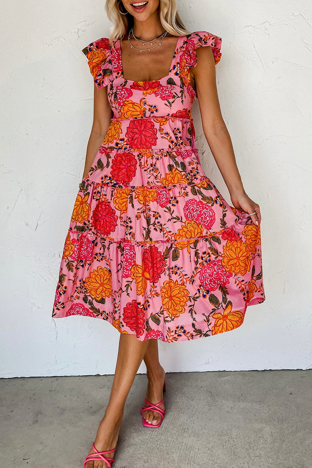 Floral square neck ruffled flutter sleeve tiered midi dress with vibrant floral pattern.