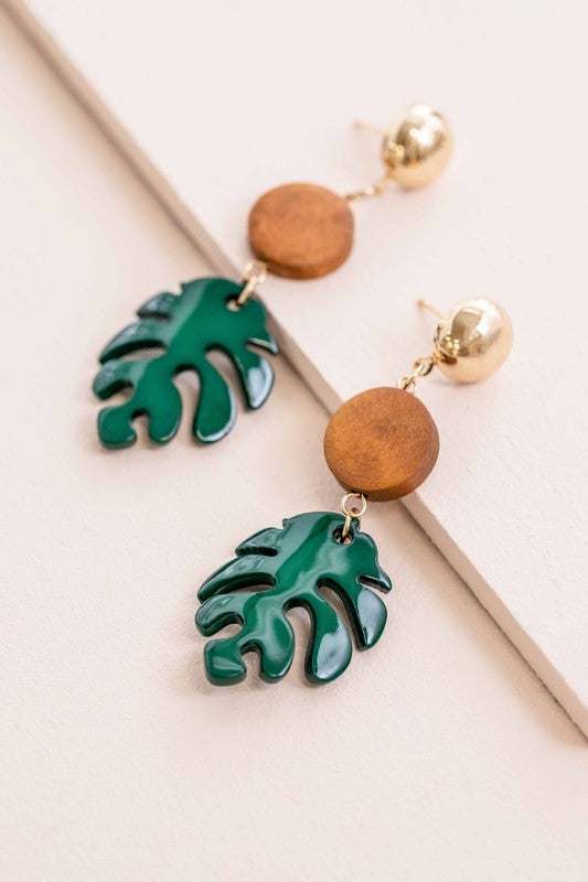 Tropical Vacation Leaf Dangle Earrings in green and wood design on display.