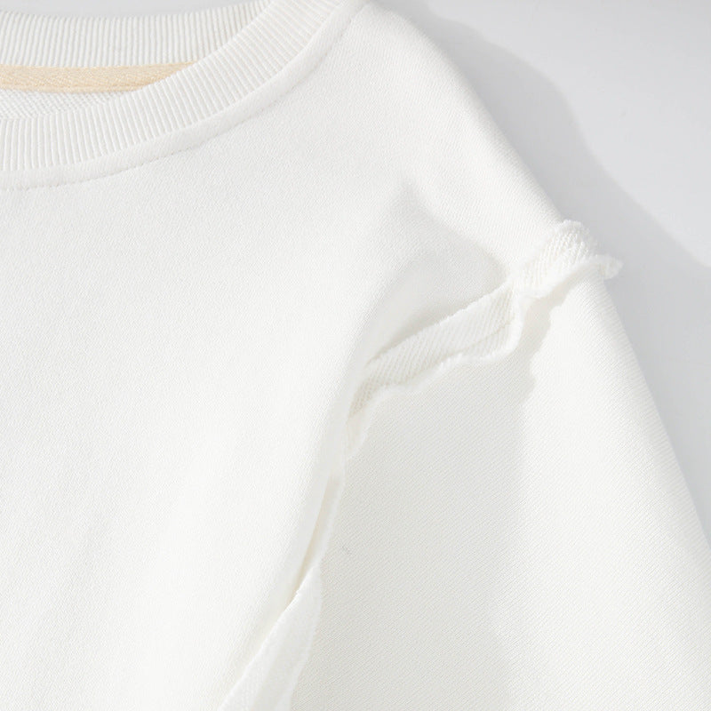 Exposed seam high-low white long sleeve sweatshirt made of 100% cotton.