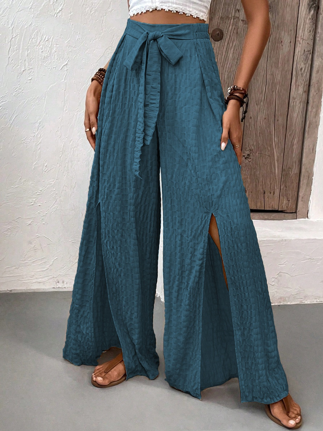 Honey Tied Slit Wide Leg Pants in teal with front slits, tied waist, made of polyester and elastane.