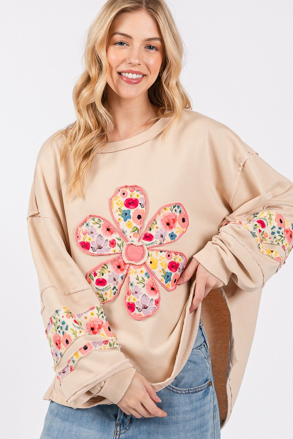 Daisy Patch Applique Long Sleeve Sweatshirt with floral design and exposed seam details.