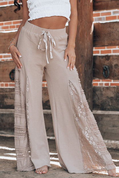 Smoke gray lace patchwork wide leg high waist pants with drawstring waist and lace details.