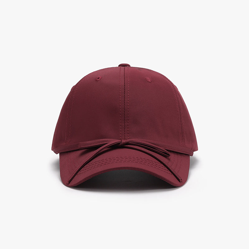 Women's cotton baseball cap with tied bow design, maroon color.