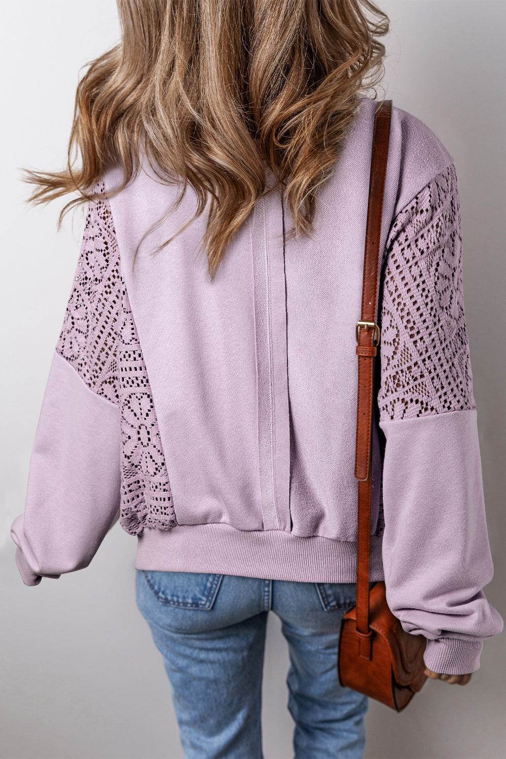 Boho crochet round neck long sleeve sweatshirt with cutout design in purple.