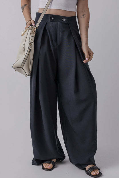 Dual buttoned high waist pleated wide leg pants with adjustable fit and flowing style.