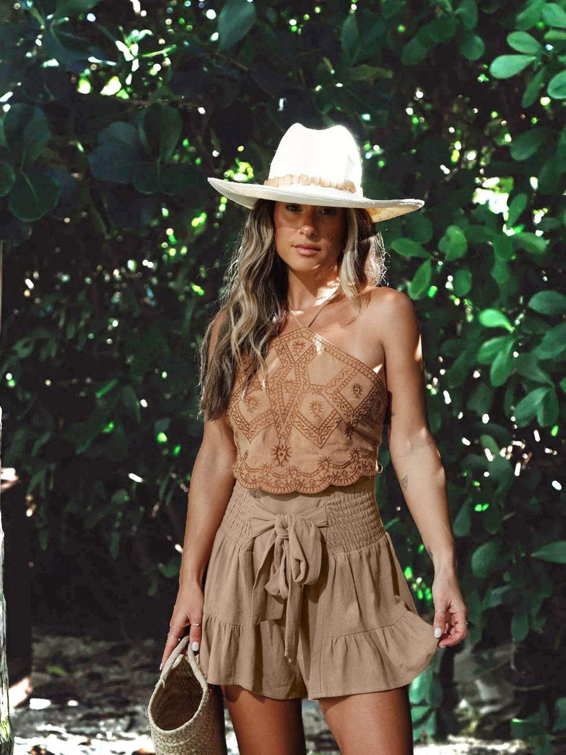 Woman wearing Boho Ruffled High Waist Flowy Shorts in a natural setting.