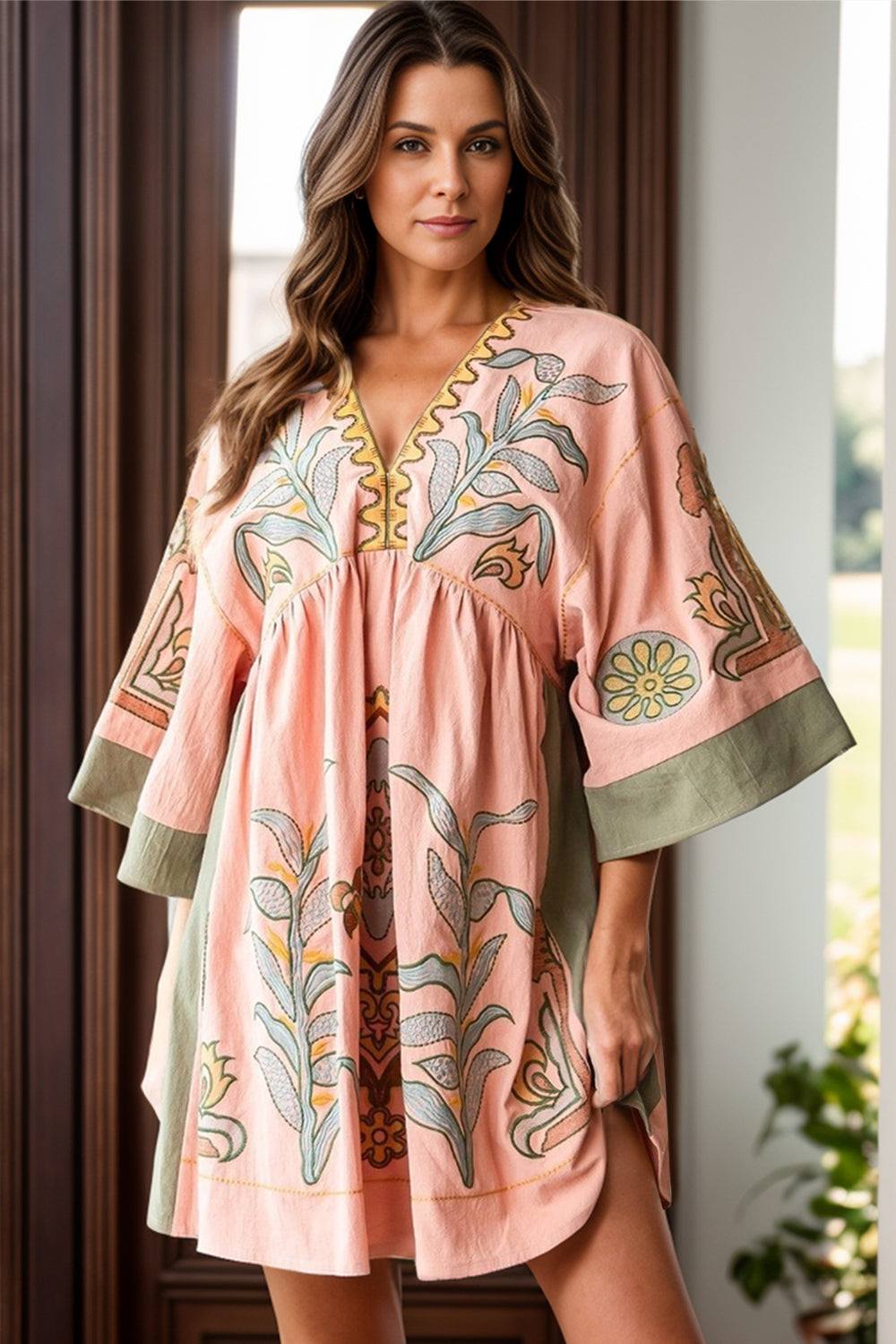 Printed V-Neck three-quarter sleeve mini dress in pink with floral patterns, made from 100% polyester.