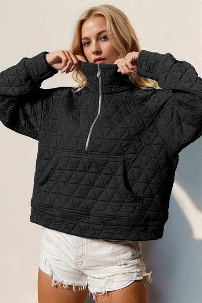 Half zip long sleeve quilted sweatshirt with pocket in black, slightly stretchy.