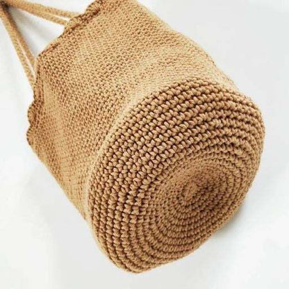 Knitted scalloped edge tote bag with braided straps and chic design.