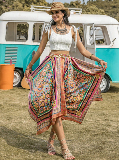 Woman wearing a colorful printed high waist handkerchief hem skirt outdoors.