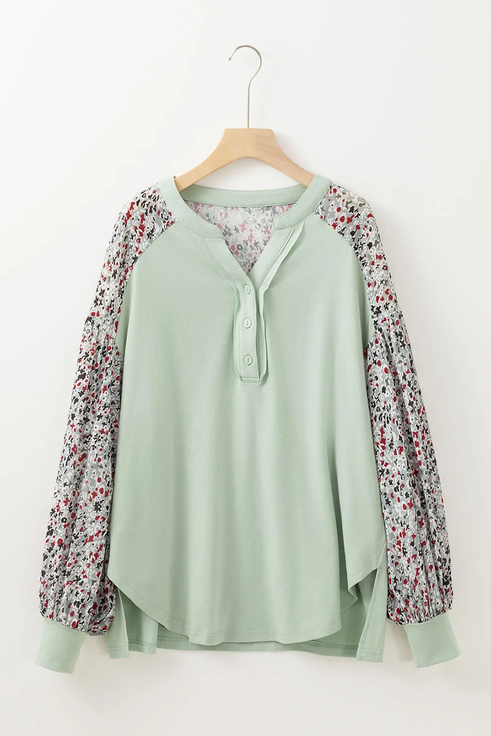 Printed notched long sleeve blouse with buttoned front and patterned sleeves.