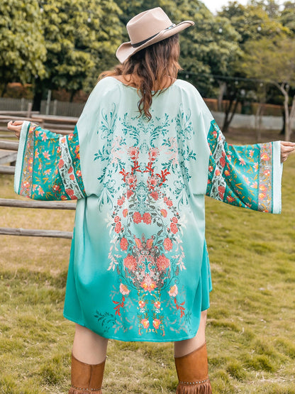 Plus size printed open front long sleeve cover up in turquoise with floral design.