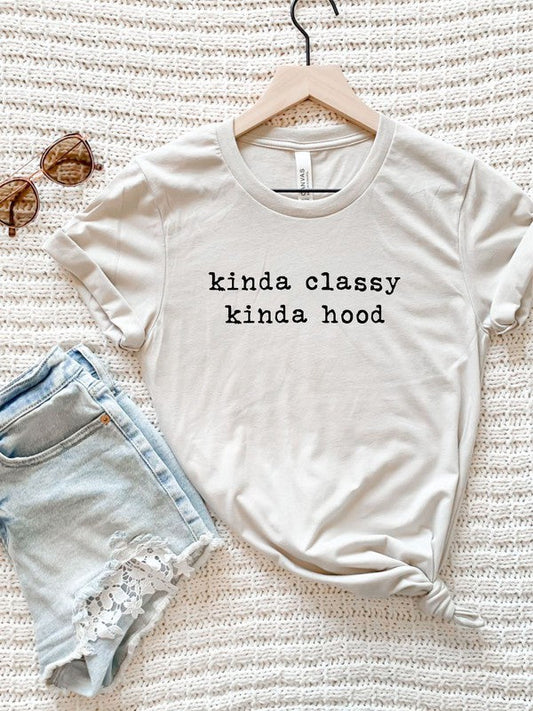 Kinda Classy Kinda Hood Graphic Tee in white on a hanger with sunglasses and denim shorts.