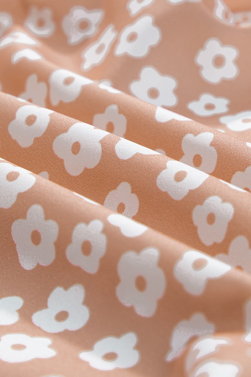 Peach-colored fabric with white floral pattern for boho wide leg pants.