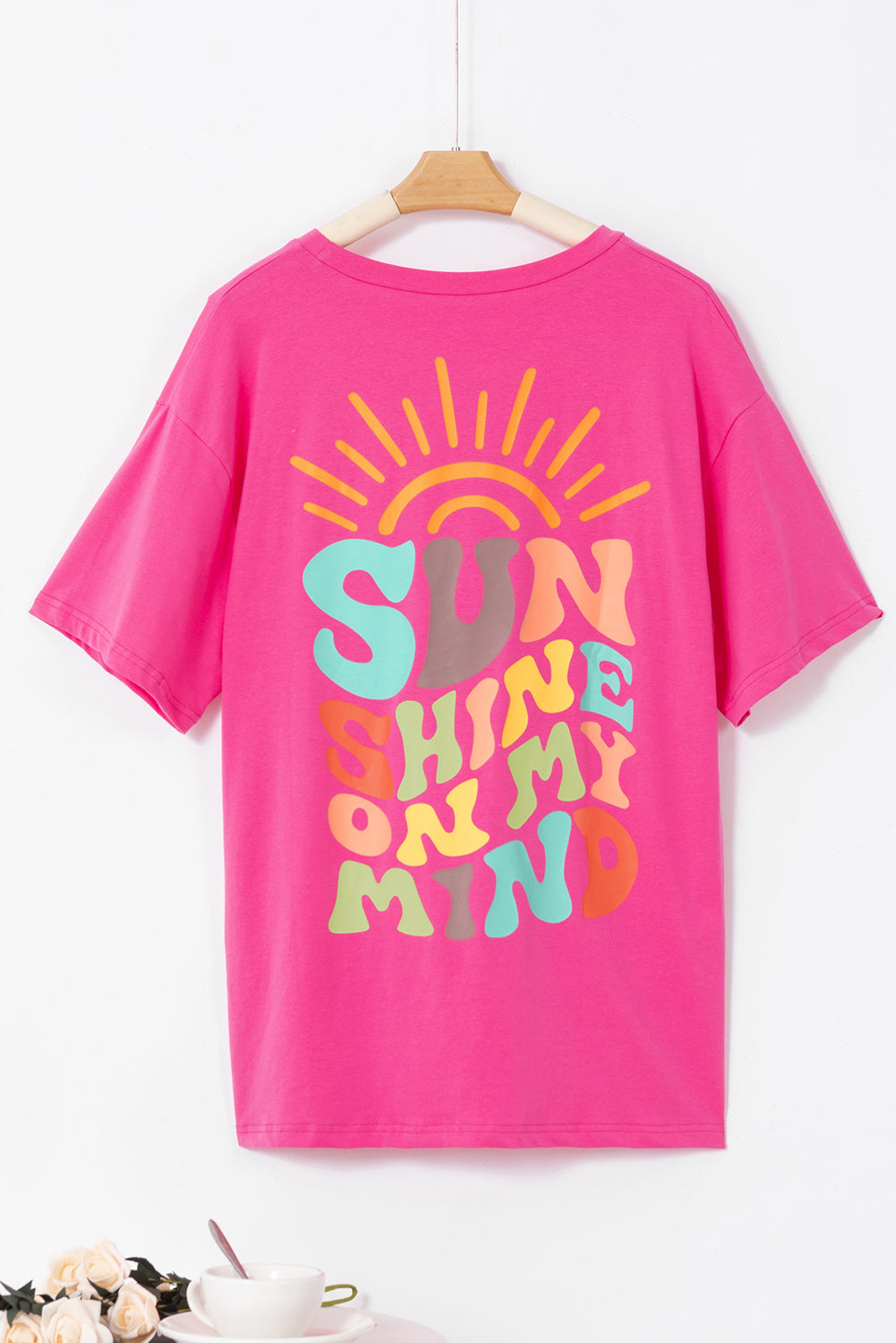 Pink "Sunshine On My Mind" graphic t-shirt with colorful text and sun design.