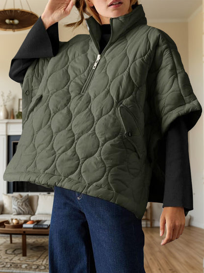 Textured half zip pullover poncho in green, featuring a quilted design with short sleeves and a relaxed fit.