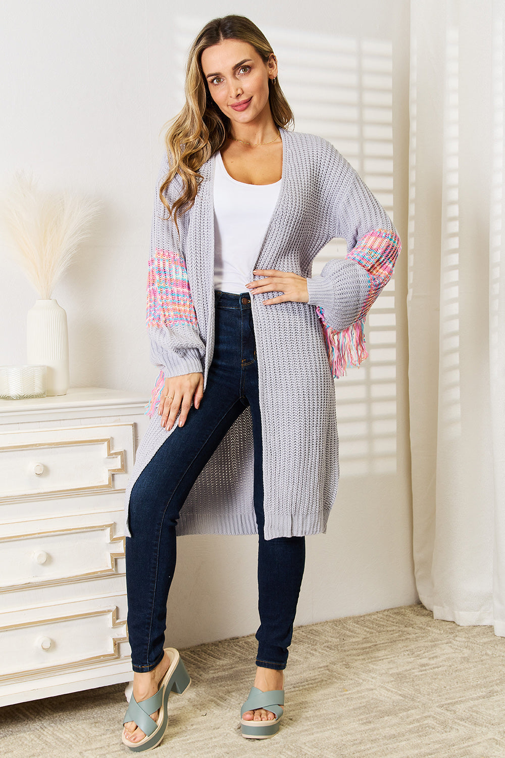 Boho style women's cardigan with woven fringe sleeves and dropped shoulders, ideal for chic layering.