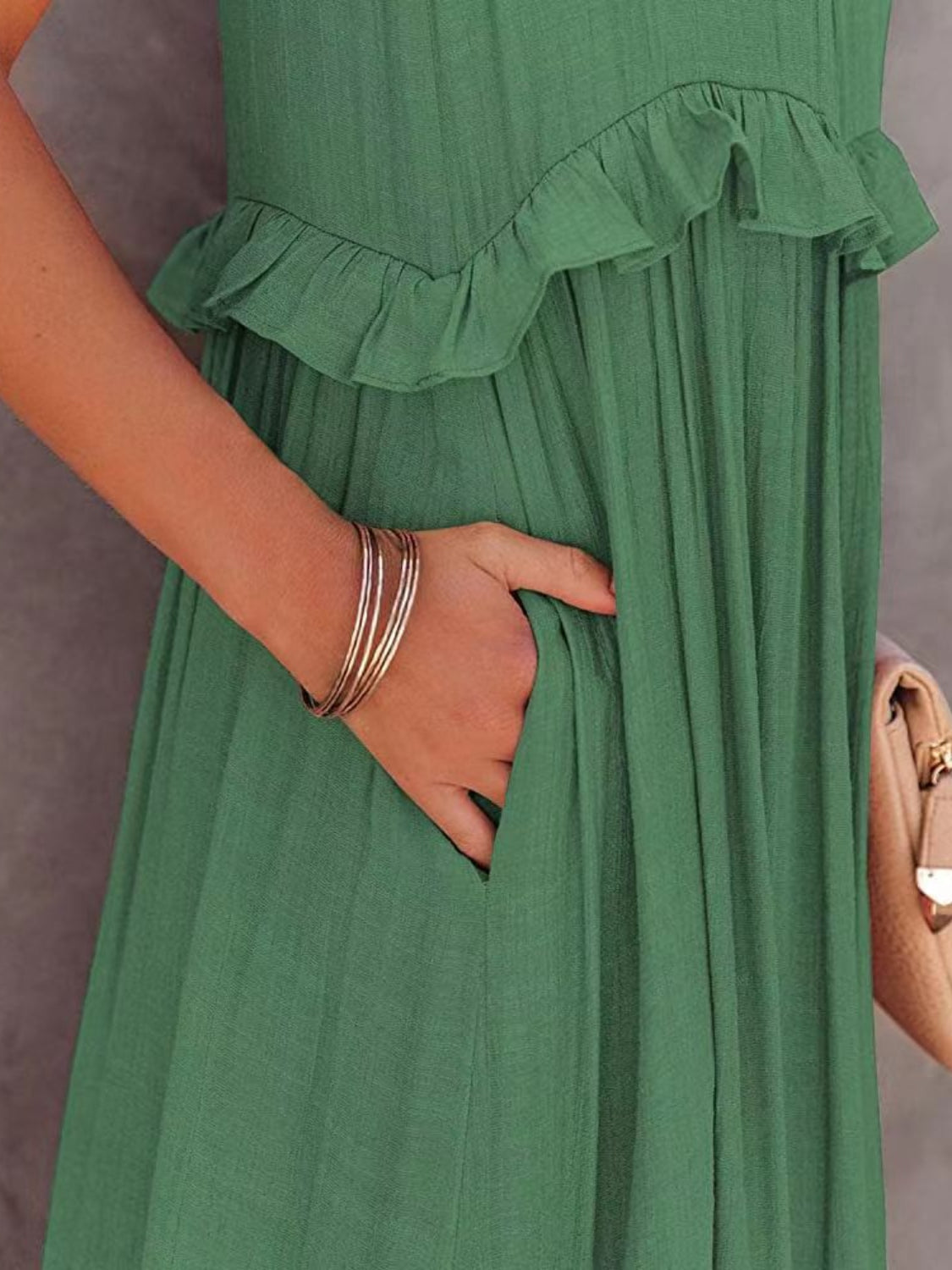 Green ruffled sleeveless tiered maxi dress with pockets.