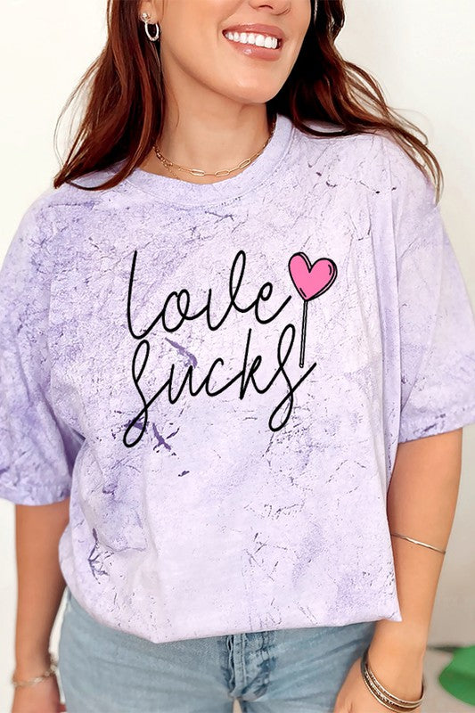 Valentine's Day Love Sucks Sucker Color Burst Graphic Tee with heart design on lilac fabric.