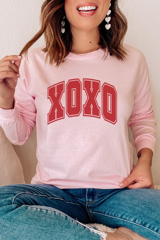 XOXO Valentine's Day Long Sleeve Graphic Tee in pink with red lettering.