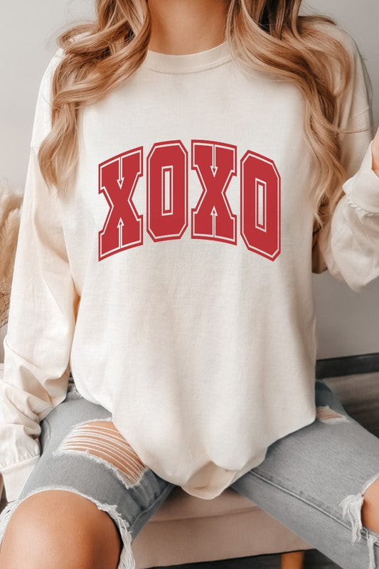 XOXO Valentine's Day long sleeve graphic tee in off-white, featuring bold red letters.