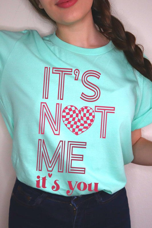 It’s Not Me It’s You Valentine's Day Graphic T-Shirt in mint green with red lettering and heart design, unisex style.