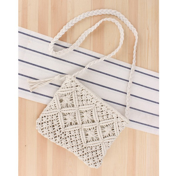 Boho Macrame Crossbody Bag with tassel accent and woven design on wooden background.