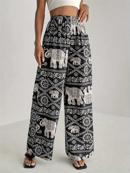 Printed wide leg elastic waist pants with elephant pattern design.