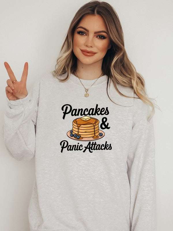 Panic Attacks Graphic Sweatshirt with pancakes design, 50% cotton 50% polyester, worn by a model.