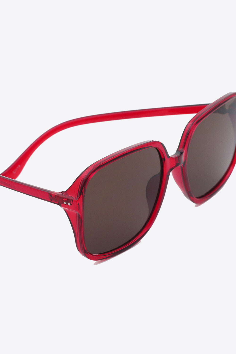 Red oversized square sunglasses with UV400 protection and polycarbonate frame.