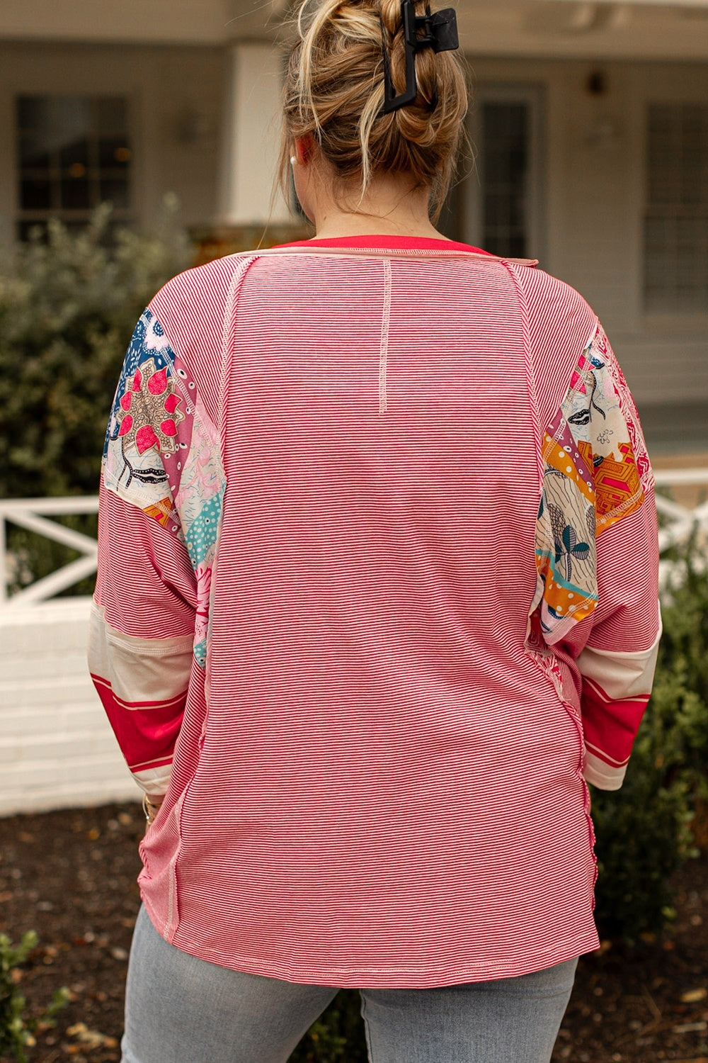 Plus size exposed seam printed striped round neck sweatshirt in pink.