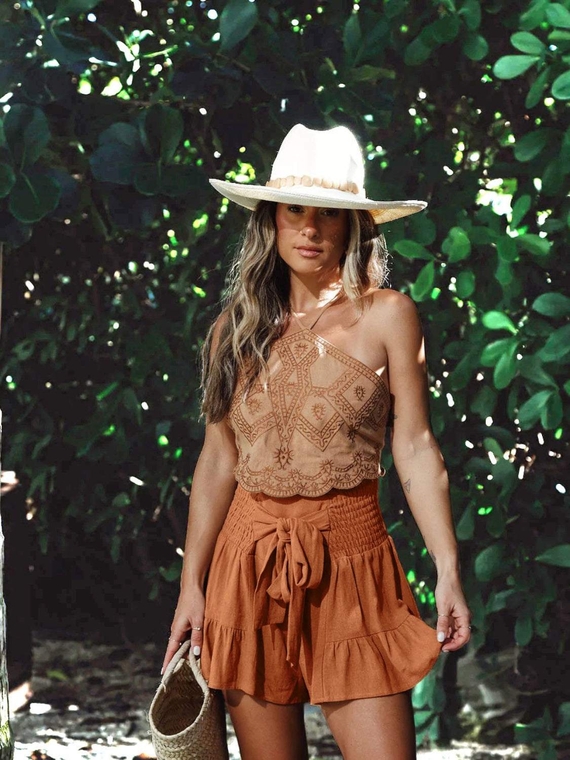 Bohemian shorts with ruffled high waist and flowy design, featuring smocked detail.