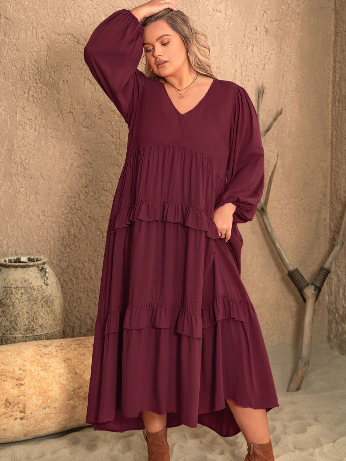 Plus size ruffled V-neck long sleeve dress with a flowing design, crafted from 100% viscose.