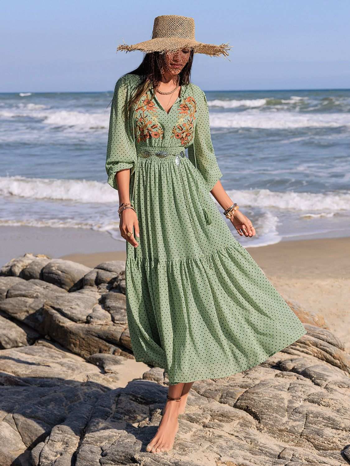 Embroidered polka dot tie neck long sleeve midi dress on woman at beach.