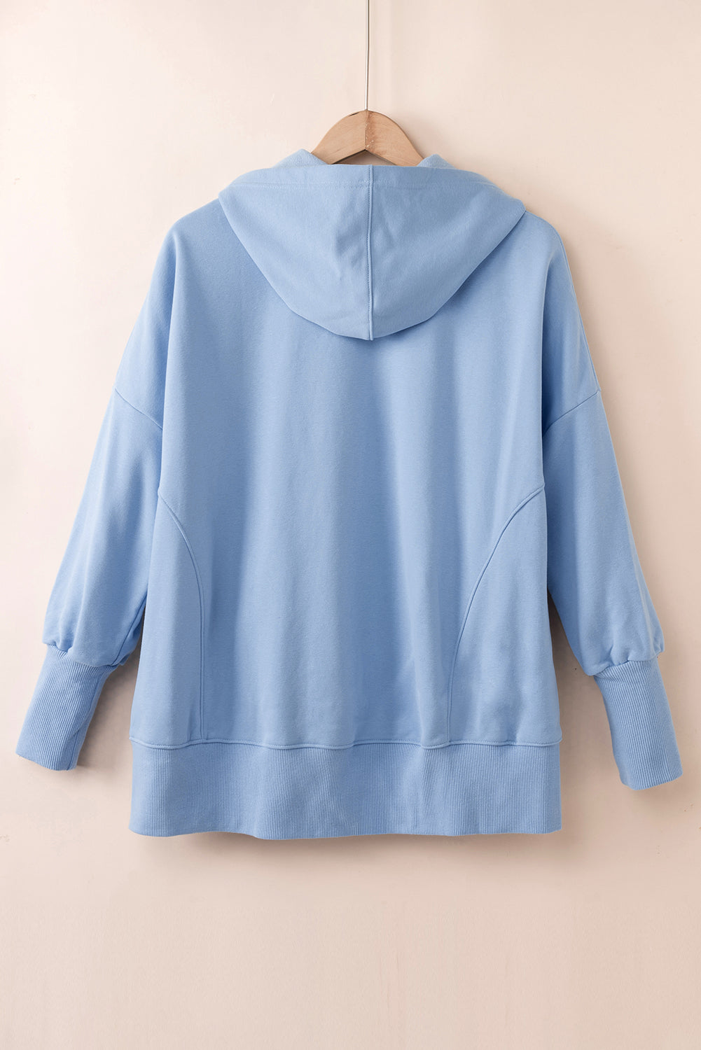 Quarter-Snap Dropped Shoulder Hoodie in blue, featuring a pocket and button details.