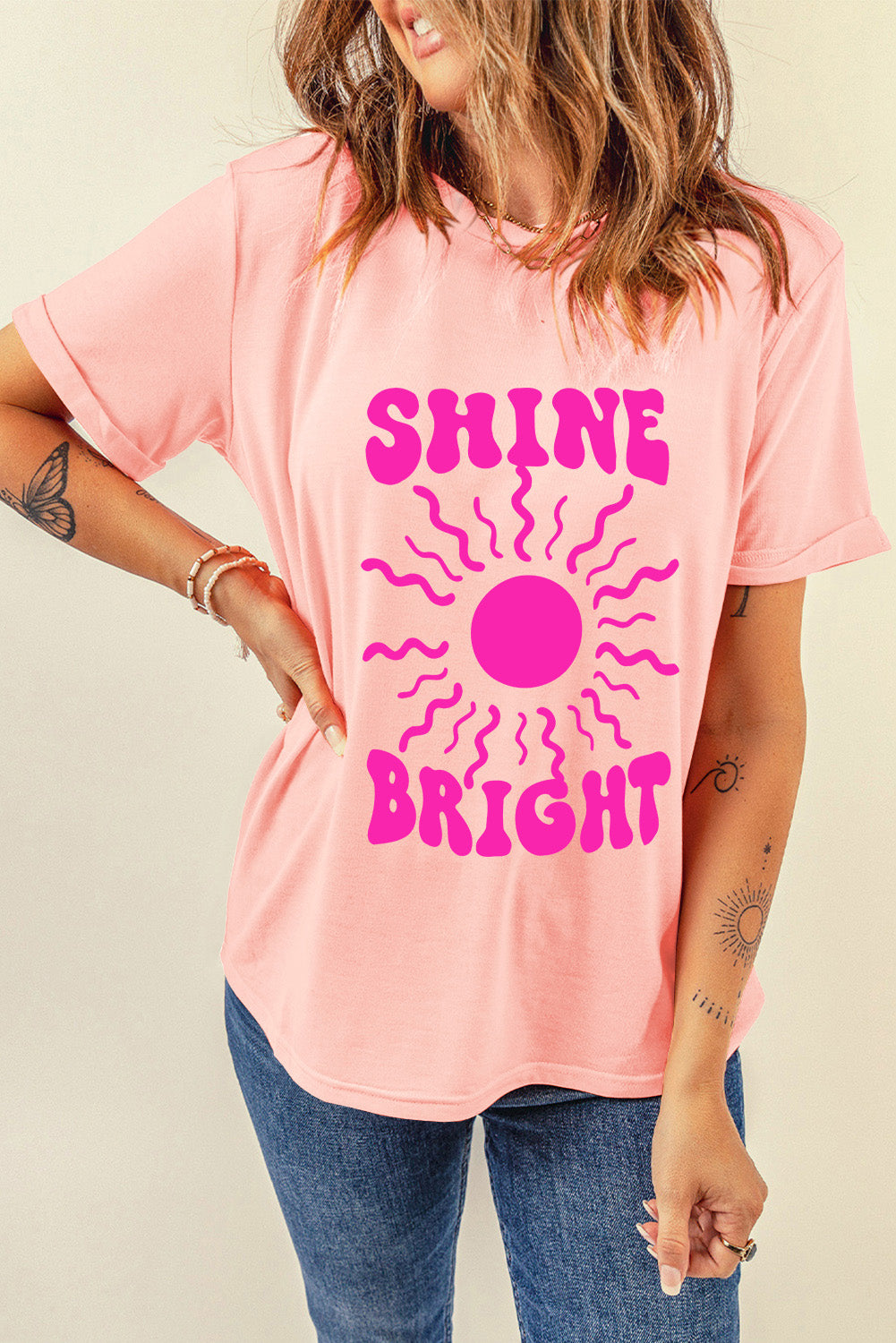 Shine Bright Graphic T-Shirt with pink sunburst design on a light pink background, basic style, polyester-cotton-elastane blend.