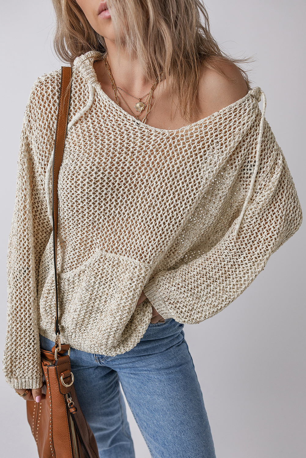 Openwork Dropped Shoulder Hooded Knit Top in beige, showcasing cutout design and relaxed fit.