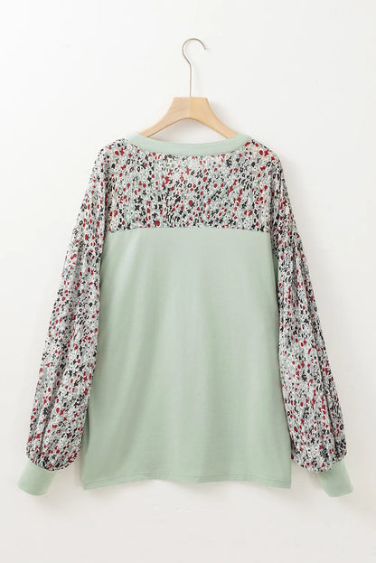 Printed notched long sleeve blouse with floral pattern, slightly stretchy polyester-cotton blend.