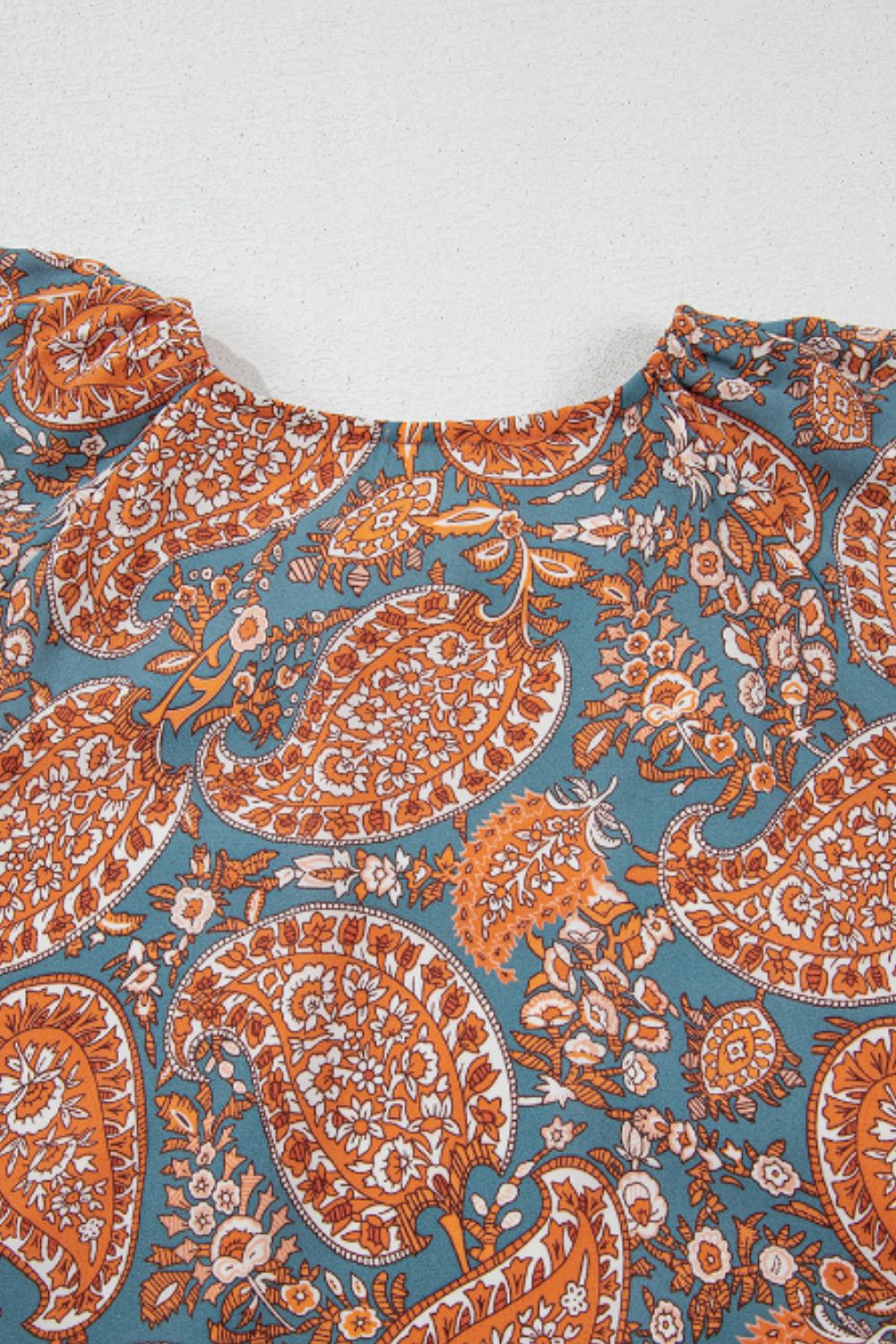 Ruffle Hem Printed Long Sleeve Dress in blue and orange paisley pattern.