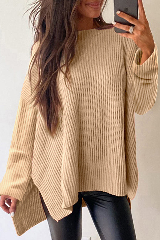 Side slit round neck long sleeve sweater in light beige with slight stretch.