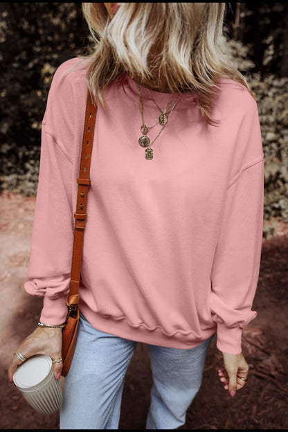 Round neck long sleeve sweatshirt in pink, featuring a slightly stretchy fabric blend of polyester, cotton, and elastane.