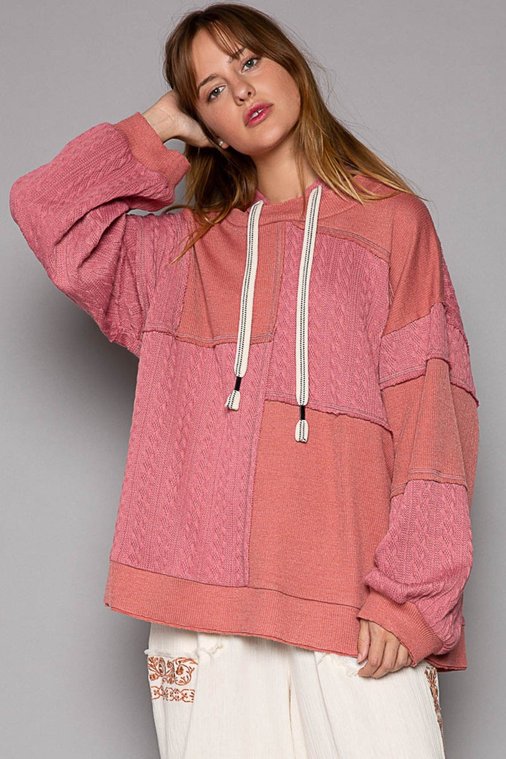 Exposed Seam Hooded Knit Top with balloon sleeves and rib-knit fabric in pink.