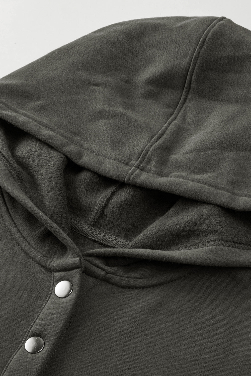 Quarter-Snap Dropped Shoulder Hoodie with buttons and pocket in dark fabric.