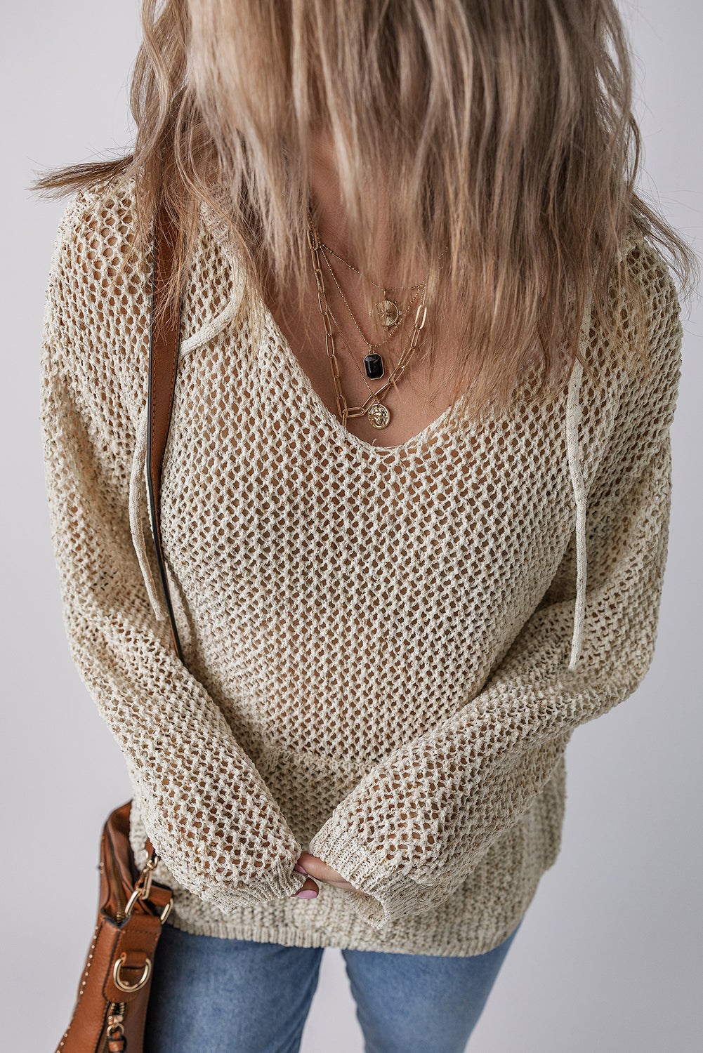 Openwork dropped shoulder hooded knit top with cutout design.