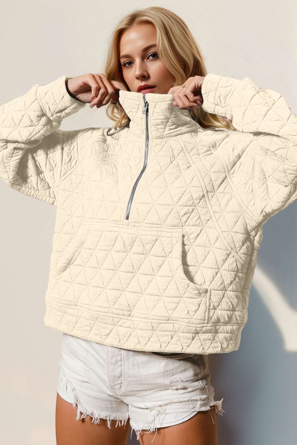 Half zip long sleeve quilted sweatshirt with pocket, slightly stretchy, machine washable, light color.