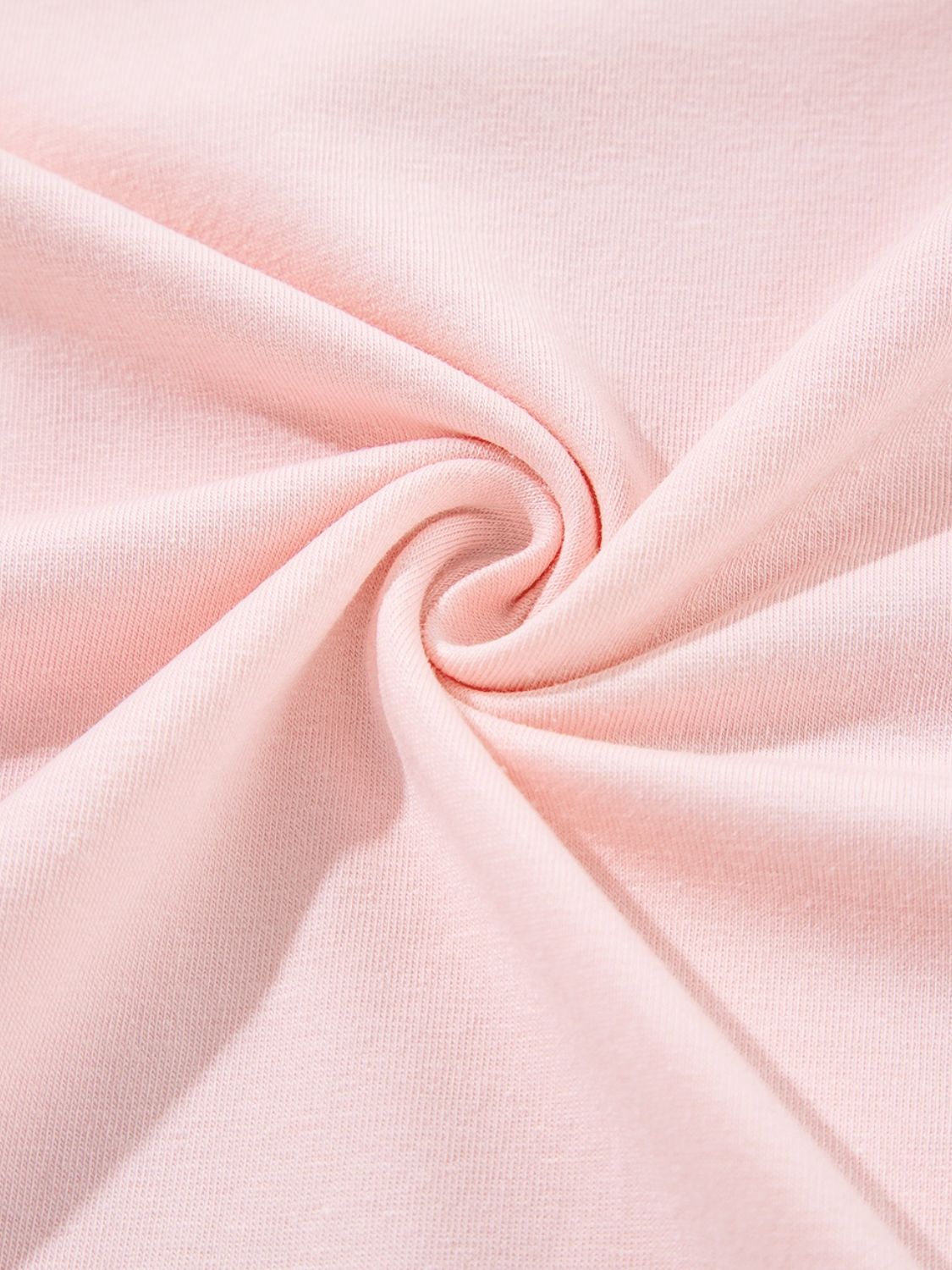 Close-up of pink fabric from Vacay Color Block Graphic T-Shirt, slightly stretchy cotton blend.