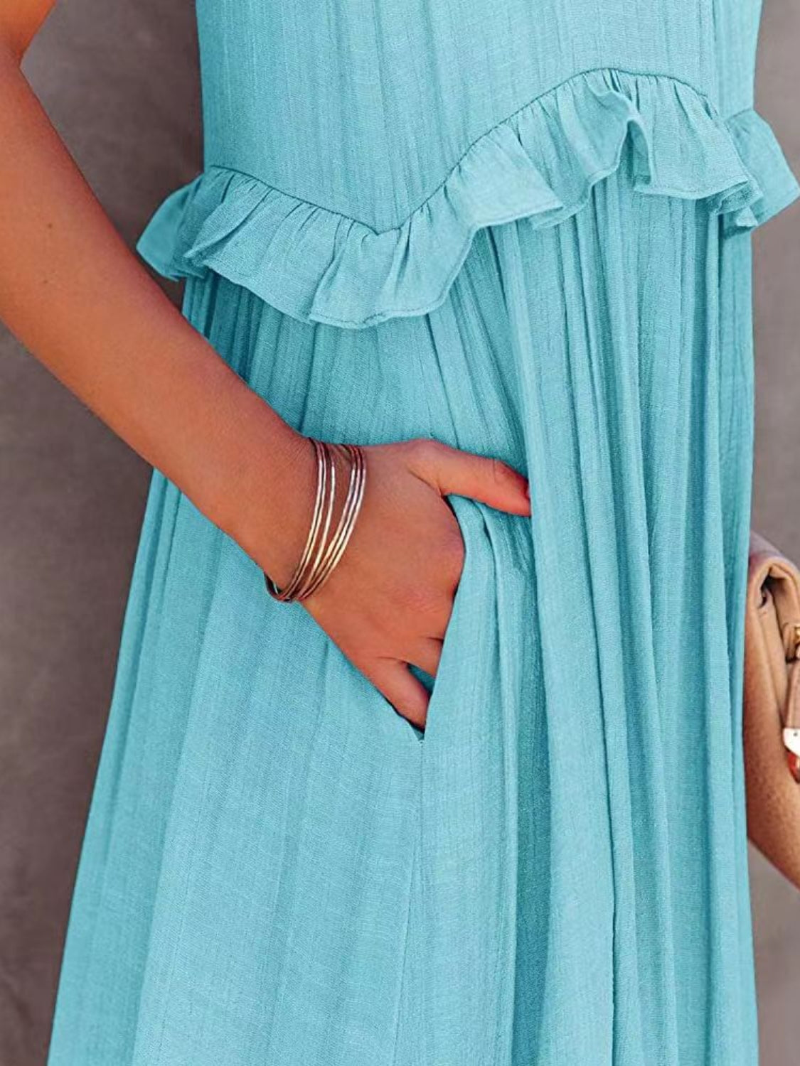 Turquoise ruffled sleeveless tiered maxi dress with pocket detail.